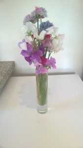 Alliums and sweet peas in vase